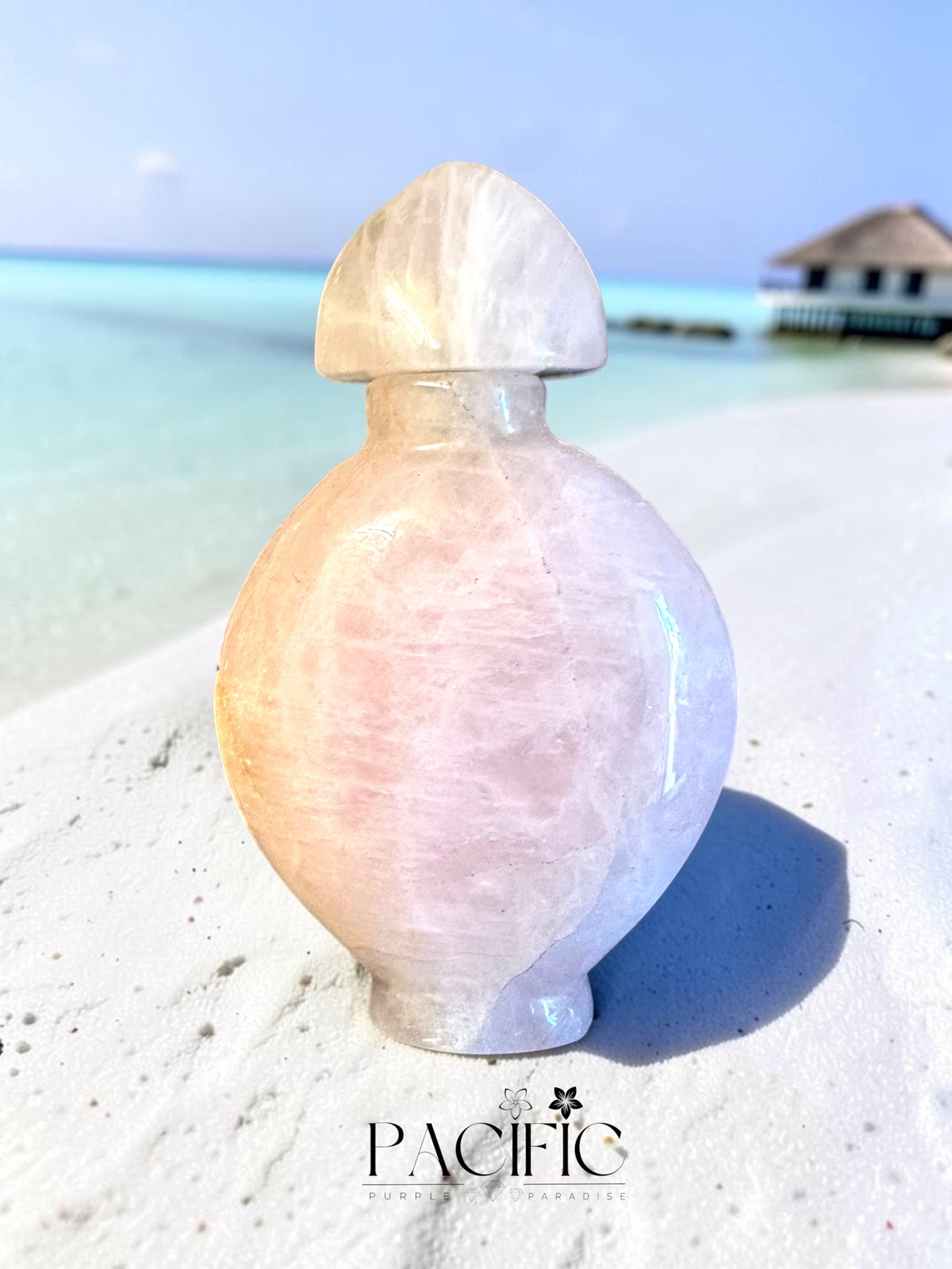 Bouteille de parfum énergétique en Quartz Rose, la pierre charge le parfum de son énergie douce